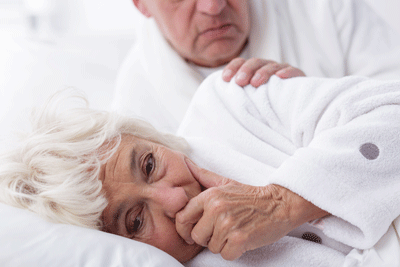 woman coughing with man comforting her